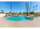 Large community pool and spa area with sun loungers, a pristine pool and well maintained landscaping at 5738 N Scottsdale Rd, Scottsdale, AZ 85253