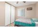 Bedroom with wood-look laminate flooring, white closet doors, and neutral walls at 6014 W Evans Dr, Glendale, AZ 85306