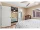 Bedroom featuring ensuite bathroom, ceiling fan, and neutral colored walls at 6014 W Evans Dr, Glendale, AZ 85306