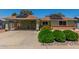 Inviting home exterior with covered parking, solar panels, and well-maintained landscaping at 6014 W Evans Dr, Glendale, AZ 85306