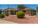Charming home featuring solar panels and vibrant landscaping with colorful decorative rock at 6014 W Evans Dr, Glendale, AZ 85306