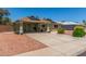 Lovely home showcasing solar panels, covered parking, and attractive decorative rock landscaping at 6014 W Evans Dr, Glendale, AZ 85306