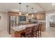Modern kitchen with stainless steel appliances, ample counter space, and stylish hanging pendant lights at 6014 W Evans Dr, Glendale, AZ 85306