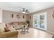 Comfortable living room featuring neutral walls, stylish decor, and doors leading to a pool view at 6014 W Evans Dr, Glendale, AZ 85306