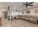 Spacious living room features modern ceiling fans, neutral tones, and stylish wood-look flooring at 6014 W Evans Dr, Glendale, AZ 85306