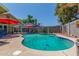 A refreshing private pool features a red umbrella and blue lounge chairs perfect for outdoor relaxation and fun at 6014 W Evans Dr, Glendale, AZ 85306