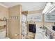Cozy bathroom featuring a toilet, vanity, shower with a partial glass block wall, and tiled floors at 609 E Winter Dr, Phoenix, AZ 85020