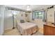 Modest bedroom with decorative shelves, light wood floors, a ceiling fan, and a window view at 609 E Winter Dr, Phoenix, AZ 85020