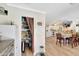 View of a kitchen with white cabinets, granite countertops, and an adjacent pantry with an open door at 609 E Winter Dr, Phoenix, AZ 85020