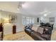 Comfortable living room featuring a leather sofa and bright lighting from the window at 609 E Winter Dr, Phoenix, AZ 85020