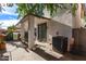 Covered back patio offers an outdoor dining area, sliding glass door and AC unit at 6343 W Sophie Ln, Laveen, AZ 85339