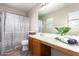 Full bathroom featuring modern vanity, spacious countertops, and shower with curtain at 6343 W Sophie Ln, Laveen, AZ 85339