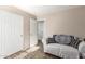 Neutral bedroom featuring a cozy couch, wood-look floors and a convenient closet at 6343 W Sophie Ln, Laveen, AZ 85339