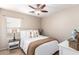 Cozy bedroom with a comfortable bed, warm lighting, and wood-look flooring at 6343 W Sophie Ln, Laveen, AZ 85339