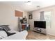 Bright bedroom features a modern desk, and large TV for relaxation and entertainment at 6343 W Sophie Ln, Laveen, AZ 85339