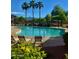 Community pool surrounded by lounge chairs, landscaping and a picnic area at 6343 W Sophie Ln, Laveen, AZ 85339