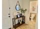 Welcoming entryway with console table, round mirror and a half bathroom at 6343 W Sophie Ln, Laveen, AZ 85339
