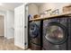 Convenient laundry room featuring updated appliances, organized storage and an open design at 6343 W Sophie Ln, Laveen, AZ 85339