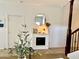 Bright living room with a decorative fireplace, round mirror and modern decorative touches at 6343 W Sophie Ln, Laveen, AZ 85339