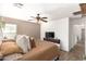 Bright main bedroom with ceiling fan, wood-look floors, large television, and ample natural light at 6343 W Sophie Ln, Laveen, AZ 85339