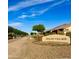 Charming Avalon Village with well-manicured lawns, lush trees, and a neighborhood sign at 6343 W Sophie Ln, Laveen, AZ 85339