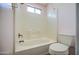 Cozy bathroom with tile surround tub and natural light at 6428 W Cordes Rd, Phoenix, AZ 85043