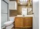Bathroom features wood-look flooring, a wood vanity, and glass door shower at 6428 W Cordes Rd, Phoenix, AZ 85043