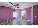 Bedroom with wood floors, ceiling fan, and a doorway that leads to the bathroom at 6428 W Cordes Rd, Phoenix, AZ 85043