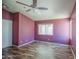 Bedroom with wood floors, ceiling fan, and a window providing natural light at 6428 W Cordes Rd, Phoenix, AZ 85043