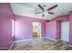 Bedroom with wood floors, ceiling fan, and a doorway leading to the bathroom at 6428 W Cordes Rd, Phoenix, AZ 85043
