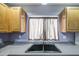 Close up on a stainless steel kitchen sink with dark countertop and wood cabinets at 6428 W Cordes Rd, Phoenix, AZ 85043