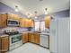 Well-lit kitchen features stainless steel appliances, wood cabinets, and a double basin sink at 6428 W Cordes Rd, Phoenix, AZ 85043