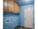 Laundry room with wood-look flooring and overhead storage at 6428 W Cordes Rd, Phoenix, AZ 85043