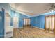Spacious living room featuring wood floors, high ceilings, and ample natural light at 6428 W Cordes Rd, Phoenix, AZ 85043