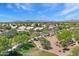 A scenic aerial view of the neighborhood with lush greenery, well-maintained homes, and mountain views at 722 N Butte Ave, Chandler, AZ 85226