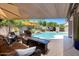 Inviting backyard patio with comfortable seating, a fire pit, and a view of the sparkling pool at 722 N Butte Ave, Chandler, AZ 85226