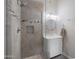 Modern bathroom features gray tiled walk-in shower with designer accents and vanity with white cabinets at 722 N Butte Ave, Chandler, AZ 85226