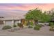 Charming home exterior with mature landscaping, a lush tree, and a well-maintained yard at 722 N Butte Ave, Chandler, AZ 85226