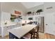 Bright kitchen featuring white cabinets, stainless appliances, quartz countertops, and an island with seating, perfect for meal preparation at 722 N Butte Ave, Chandler, AZ 85226