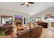 Spacious living room with vaulted ceilings, fireplace, comfortable leather furniture, and seamless flow to kitchen and backyard pool at 722 N Butte Ave, Chandler, AZ 85226