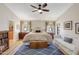 Spacious and bright main bedroom featuring a king-size bed, seating area, and access to the backyard at 722 N Butte Ave, Chandler, AZ 85226