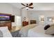 Comfortable main bedroom featuring a king-size bed, a seating area, wooden dresser, and ensuite bathroom at 722 N Butte Ave, Chandler, AZ 85226