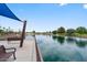 Scenic view of a tranquil pond with shaded seating, surrounded by lush landscaping at 722 N Butte Ave, Chandler, AZ 85226