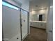 Bathroom featuring a shower with an all-glass door and a double sink vanity at 7433 W Rovey Ave, Glendale, AZ 85303
