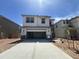 Two-story home with a two car garage, neutral paint, and a stone facade at 7433 W Rovey Ave, Glendale, AZ 85303