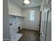 New laundry room area with bright lighting and new connections at 7433 W Rovey Ave, Glendale, AZ 85303