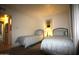 Bedroom featuring two twin beds and a gold mirror hanging on the wall at 7474 E Earll Dr # 201, Scottsdale, AZ 85251