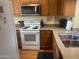 Kitchen with white appliances and a stainless steel sink with a pull-down faucet at 7474 E Earll Dr # 201, Scottsdale, AZ 85251