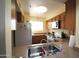 Well-lit kitchen with wood cabinets, granite countertops and stainless steel appliances at 7474 E Earll Dr # 201, Scottsdale, AZ 85251