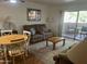 Living room with wood floors, comfy seating, area rug and access to an outdoor patio at 7474 E Earll Dr # 201, Scottsdale, AZ 85251